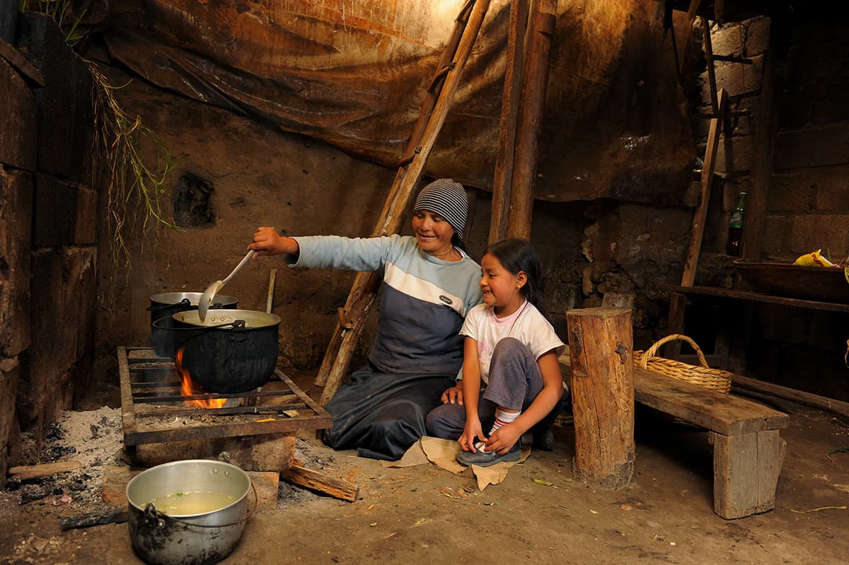 A woman and young girl cooking together