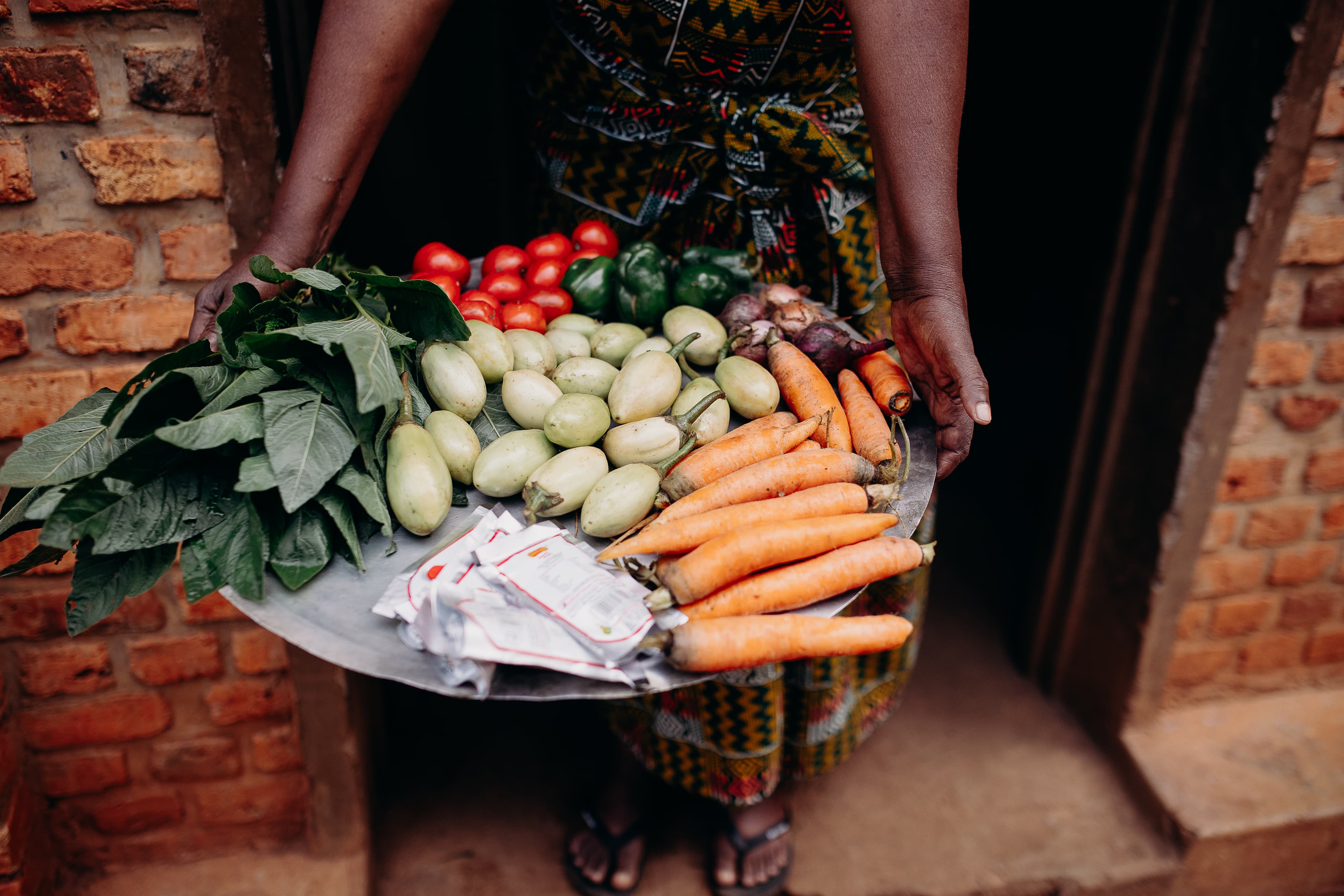 A large metal platter of fruits and vegetables.