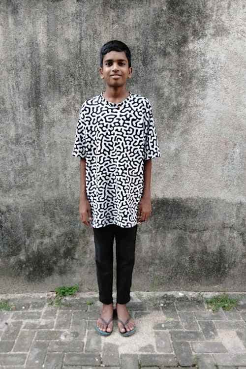 An unsponsored boy named Prasanna from Sri Lanka who has waited 523 days for a sponsor.