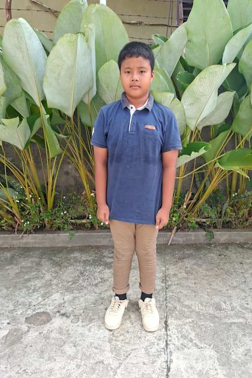 An unsponsored boy named Gilbert from Indonesia who has waited 544 days for a sponsor.