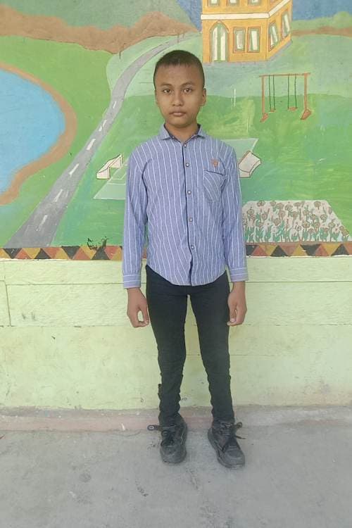 An unsponsored boy named Toni from Indonesia who has waited 593 days for a sponsor.