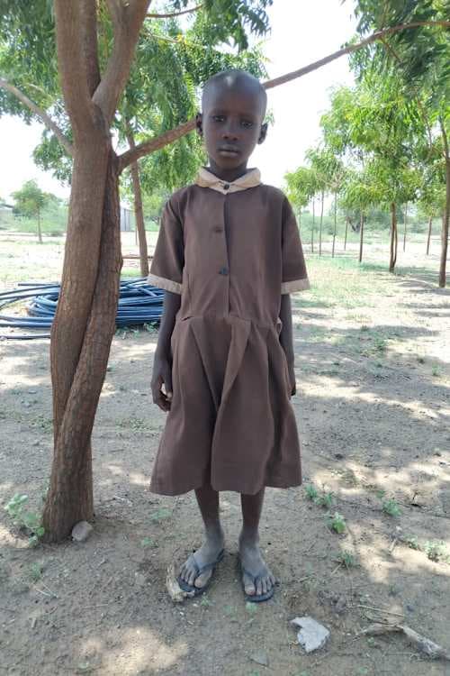 An unsponsored girl named Ajikon from Kenya who lives in an AIDS-affected area and has waited 616 days for a sponsor.