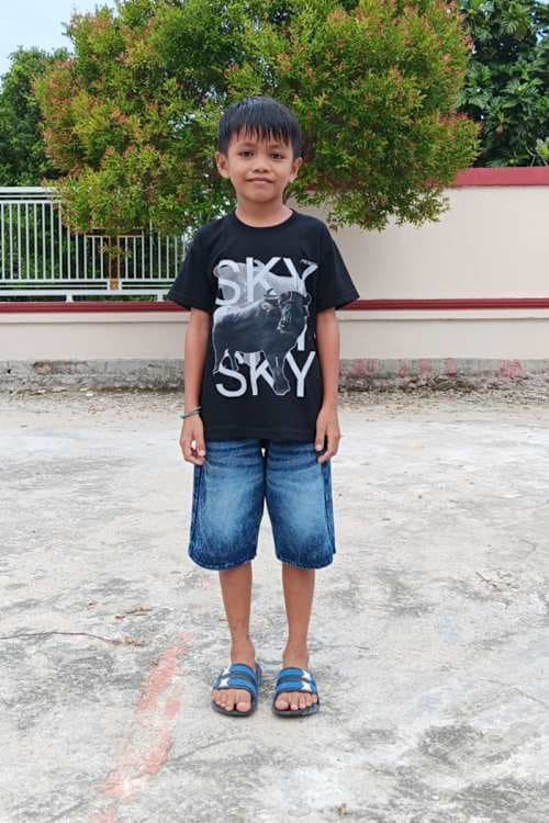 An unsponsored boy named Gilang from Indonesia who has waited 584 days for a sponsor.