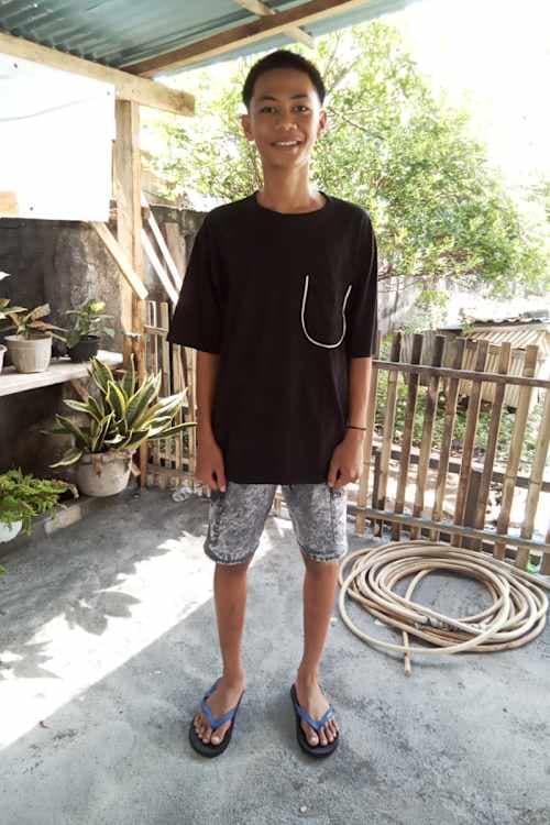 An unsponsored boy named Putra from Indonesia who has waited 541 days for a sponsor.