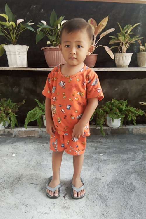 An unsponsored boy named Jastin from Indonesia who has waited 595 days for a sponsor.