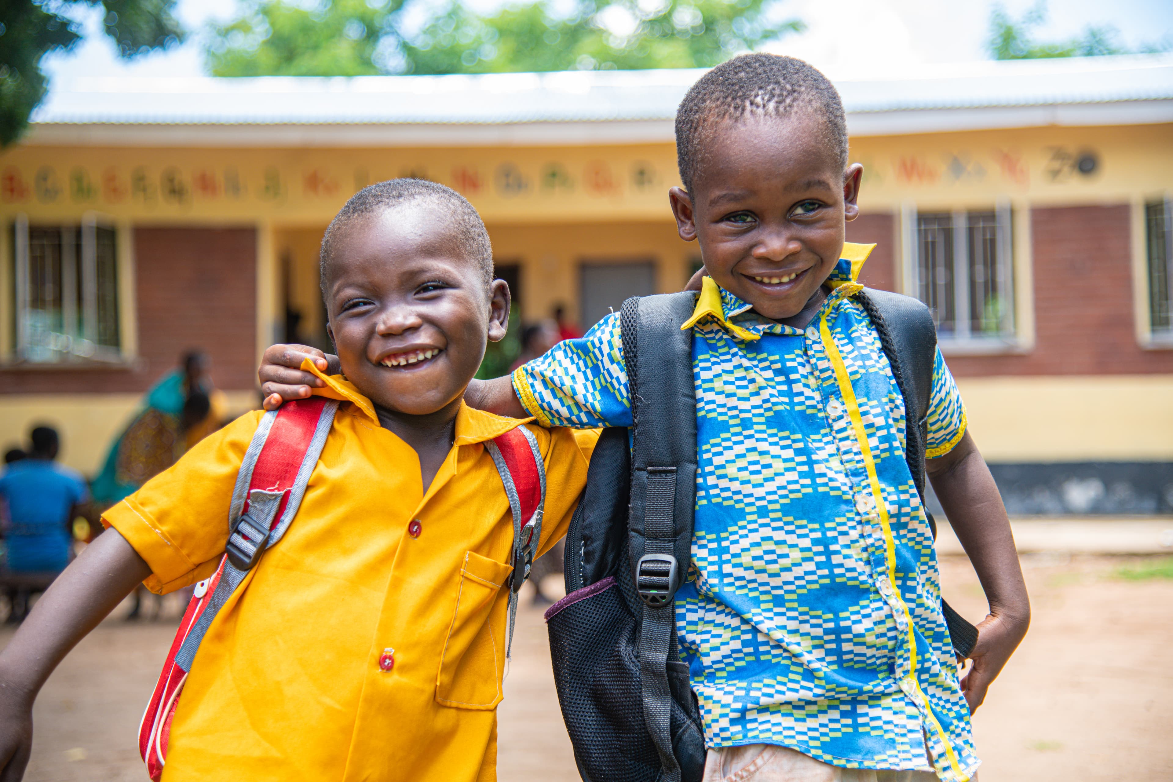 Two young African boys smile for the camera.