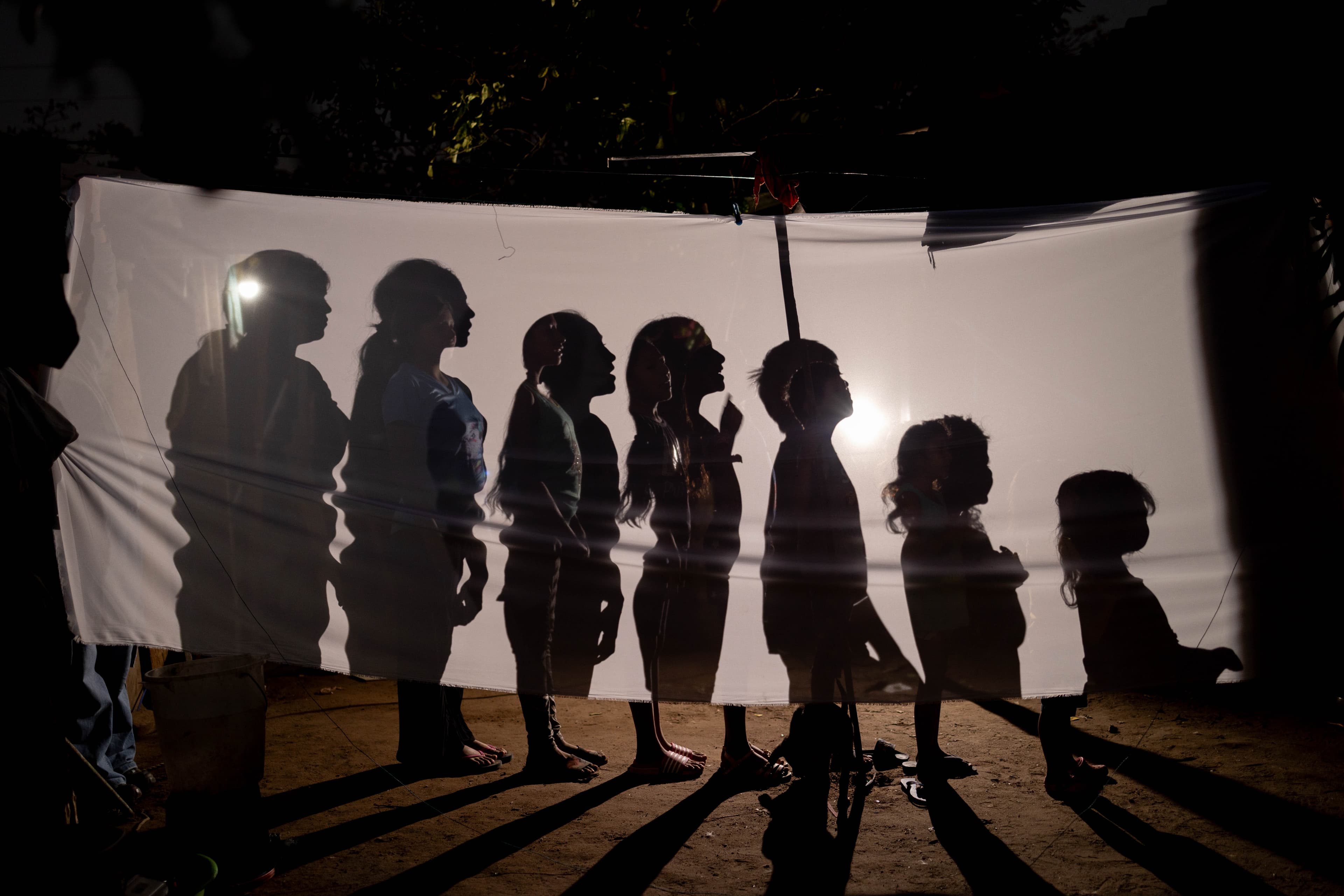 Silhouette of seven children lined up from shortest to tallest