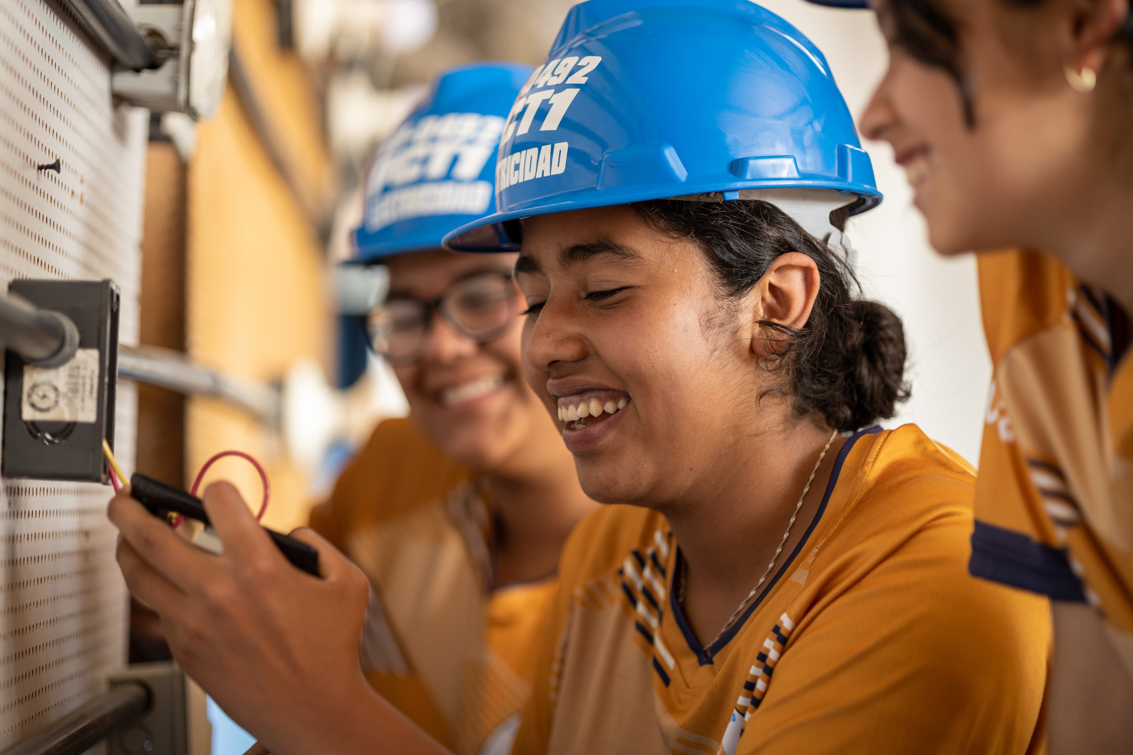 A young woman works on building an electrical circuit.