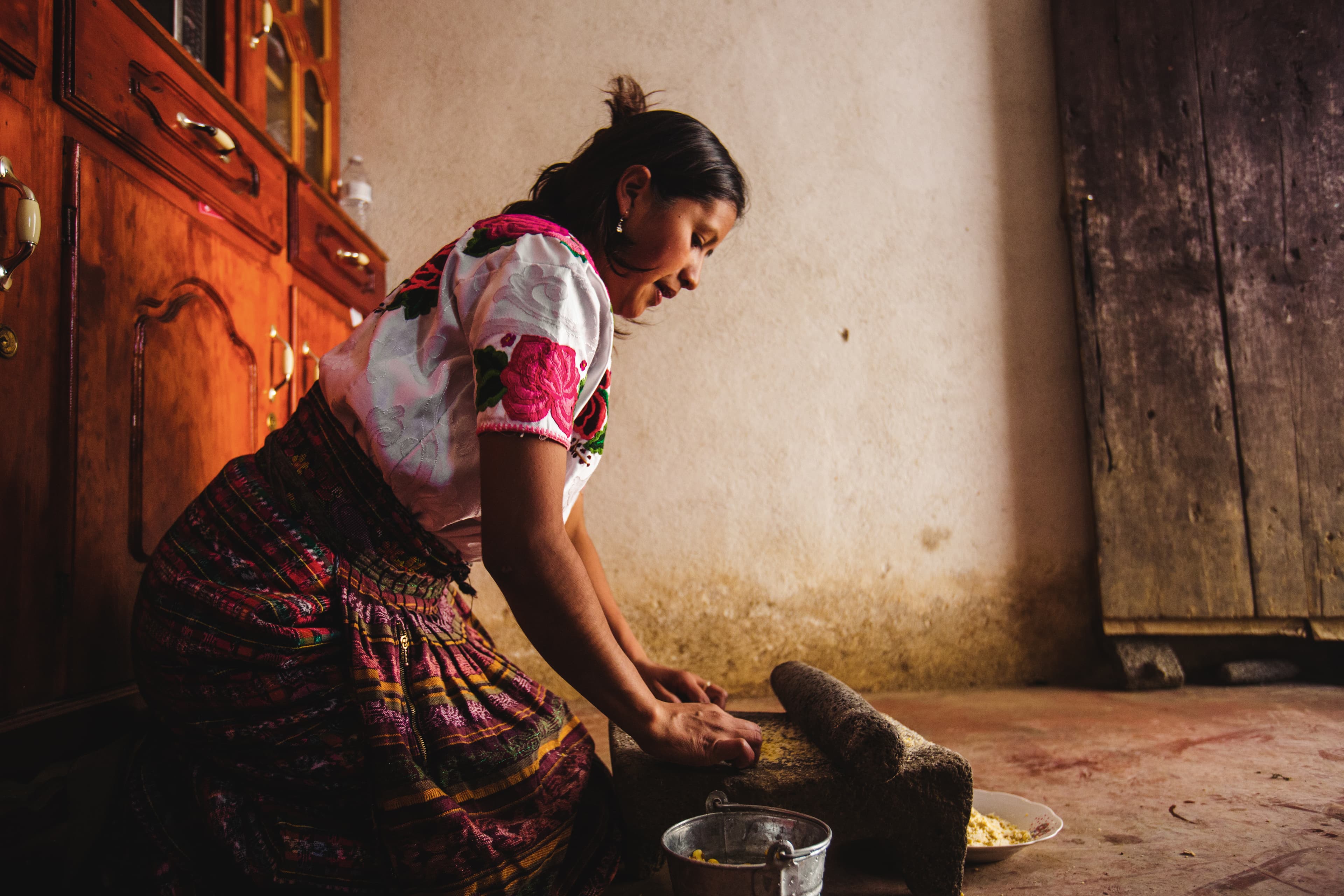 A mother is preparing food in her kitchen.