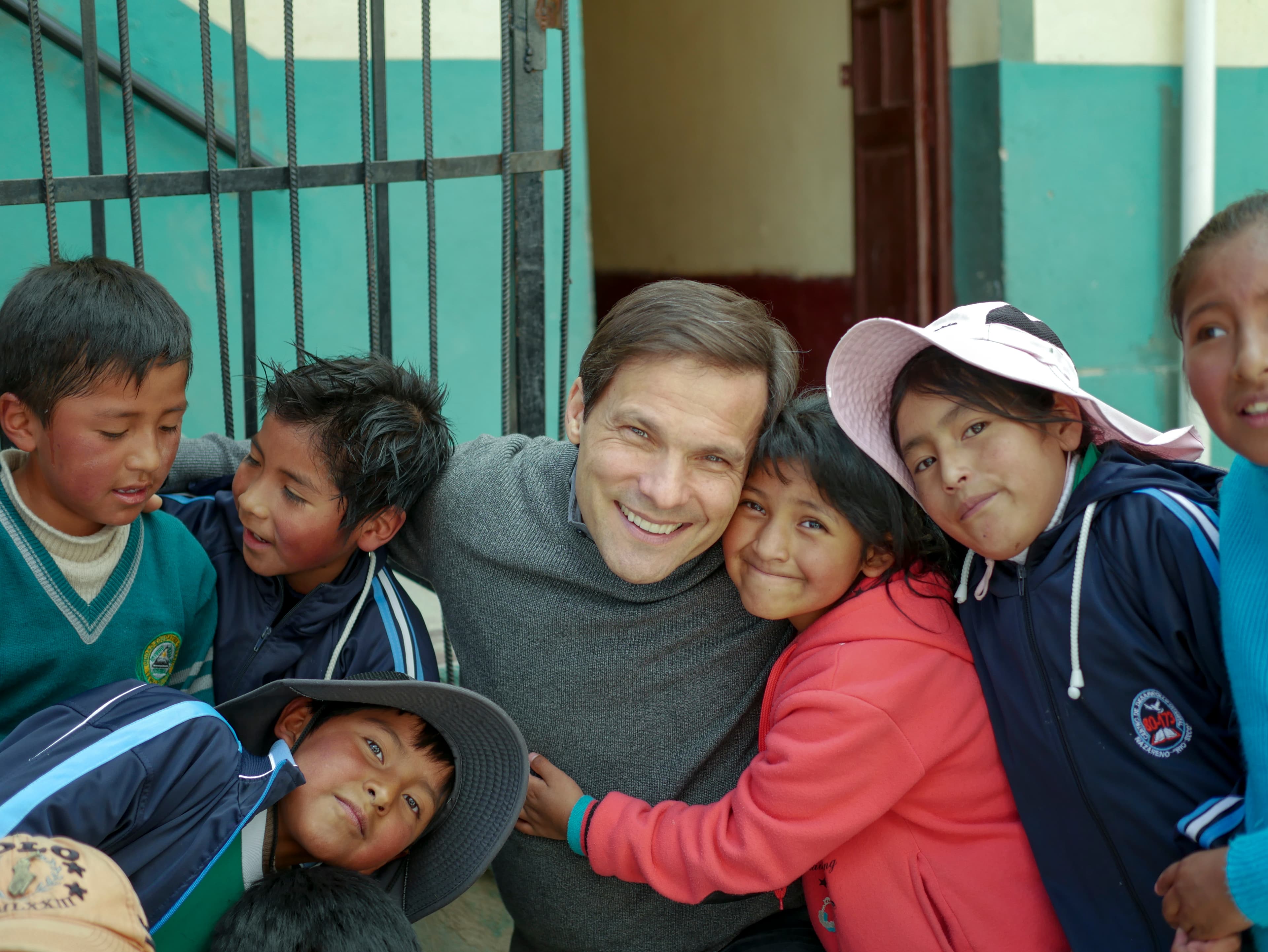 Compassion International president Jimmy Mellado stands with children in Bolivia.