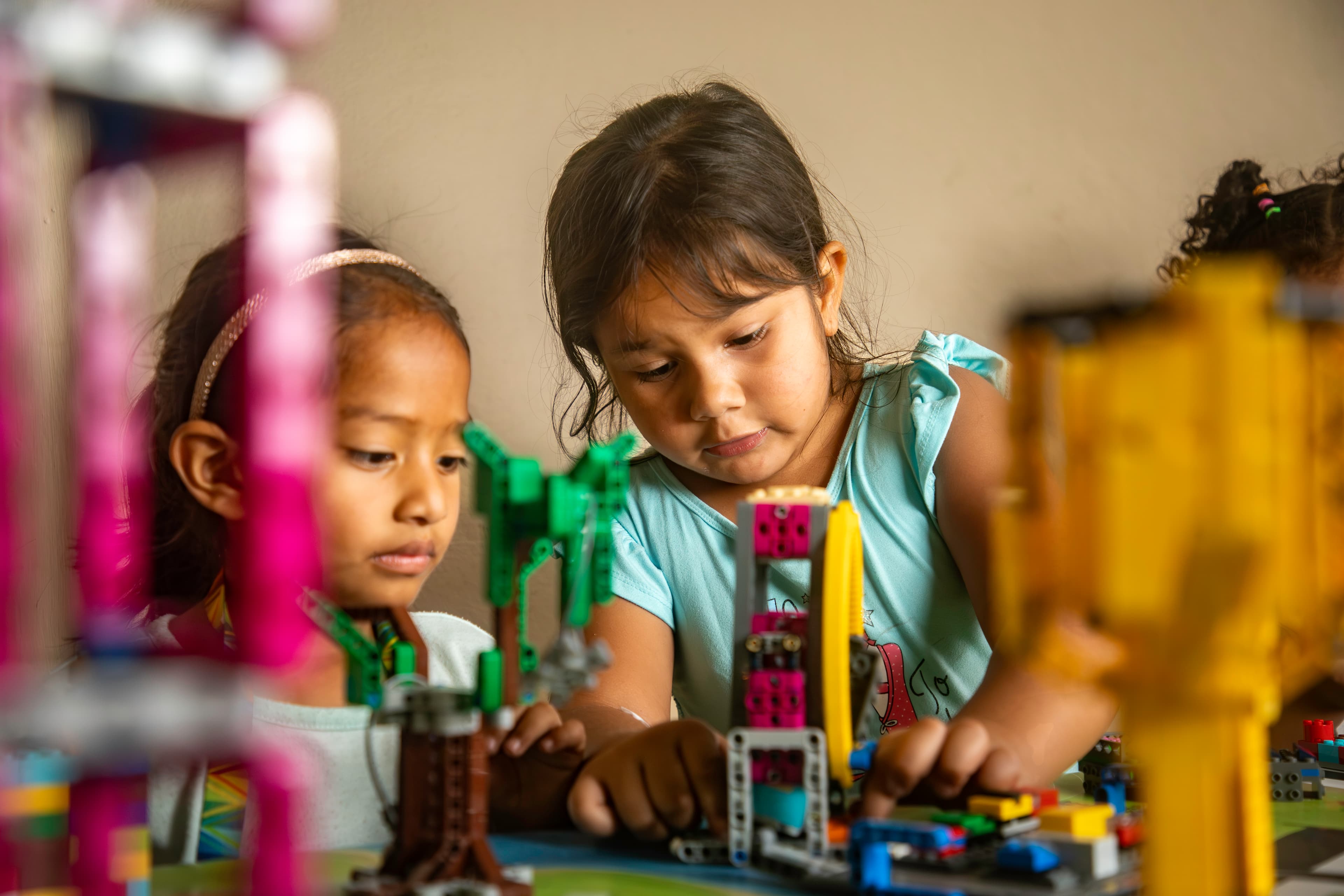 Two young girls assemble a lego-piece windmill they construct to compete in the first Lego League.