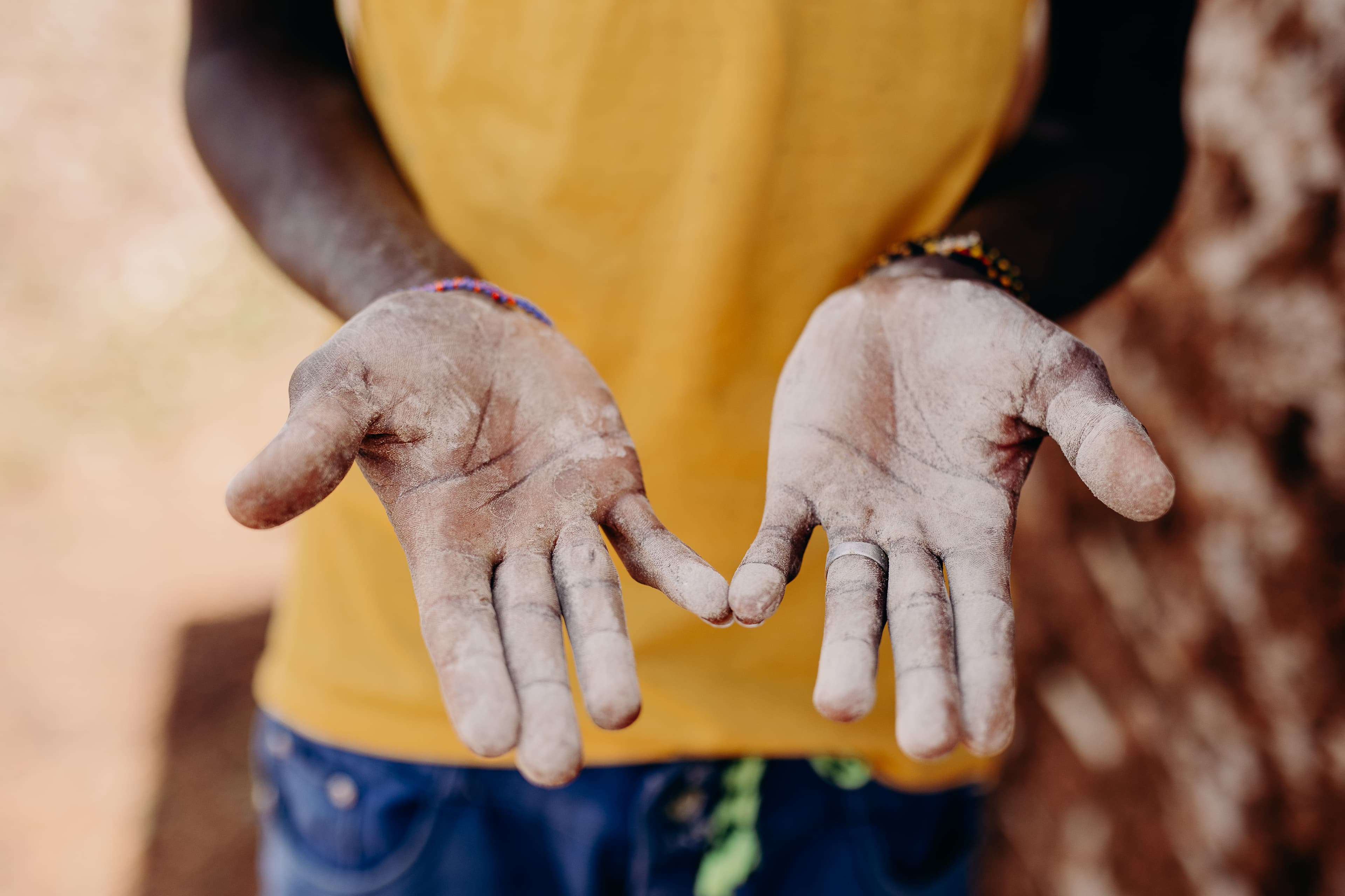 An African man’s hands covered in dust.