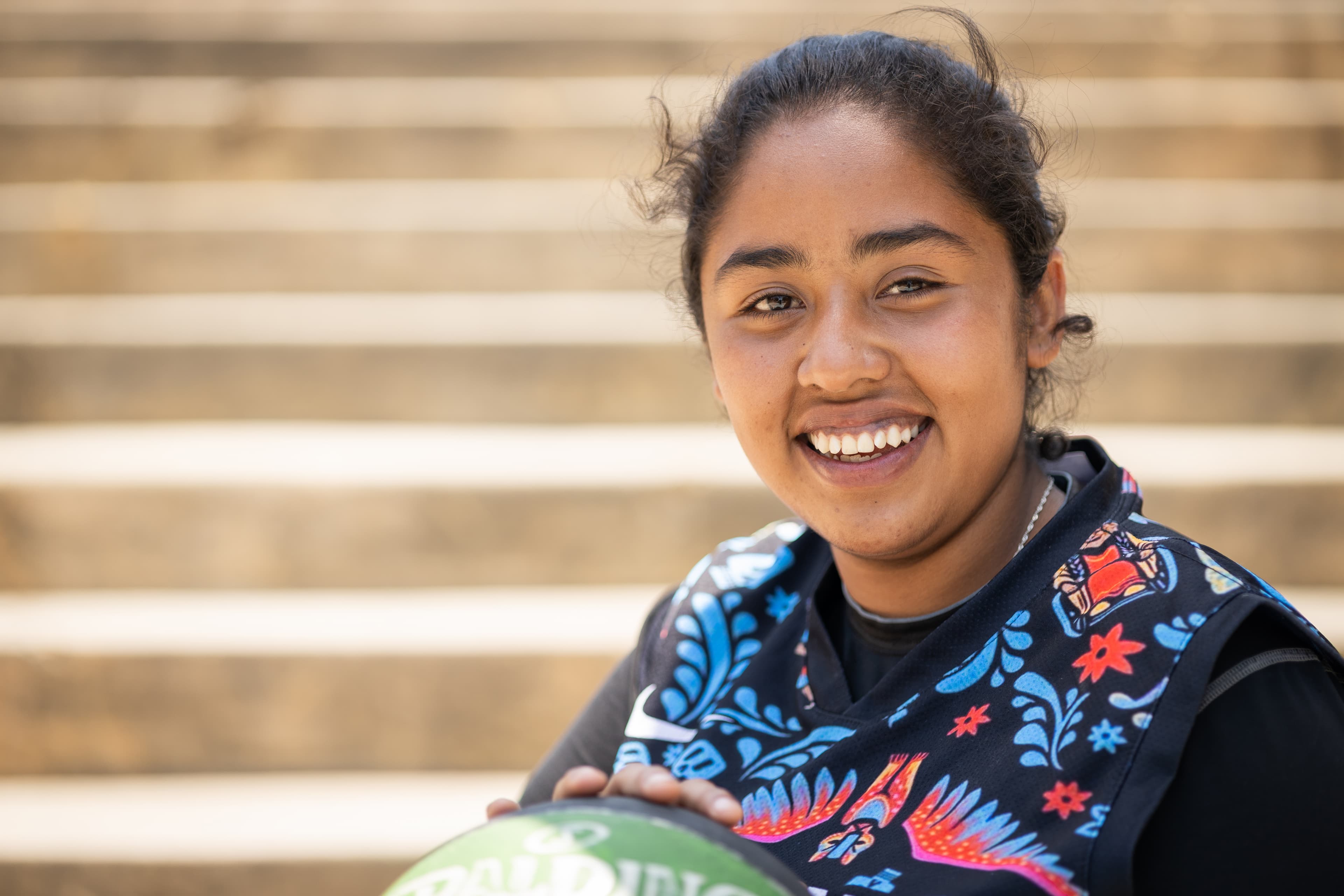 A young woman is smiling at the camera.
