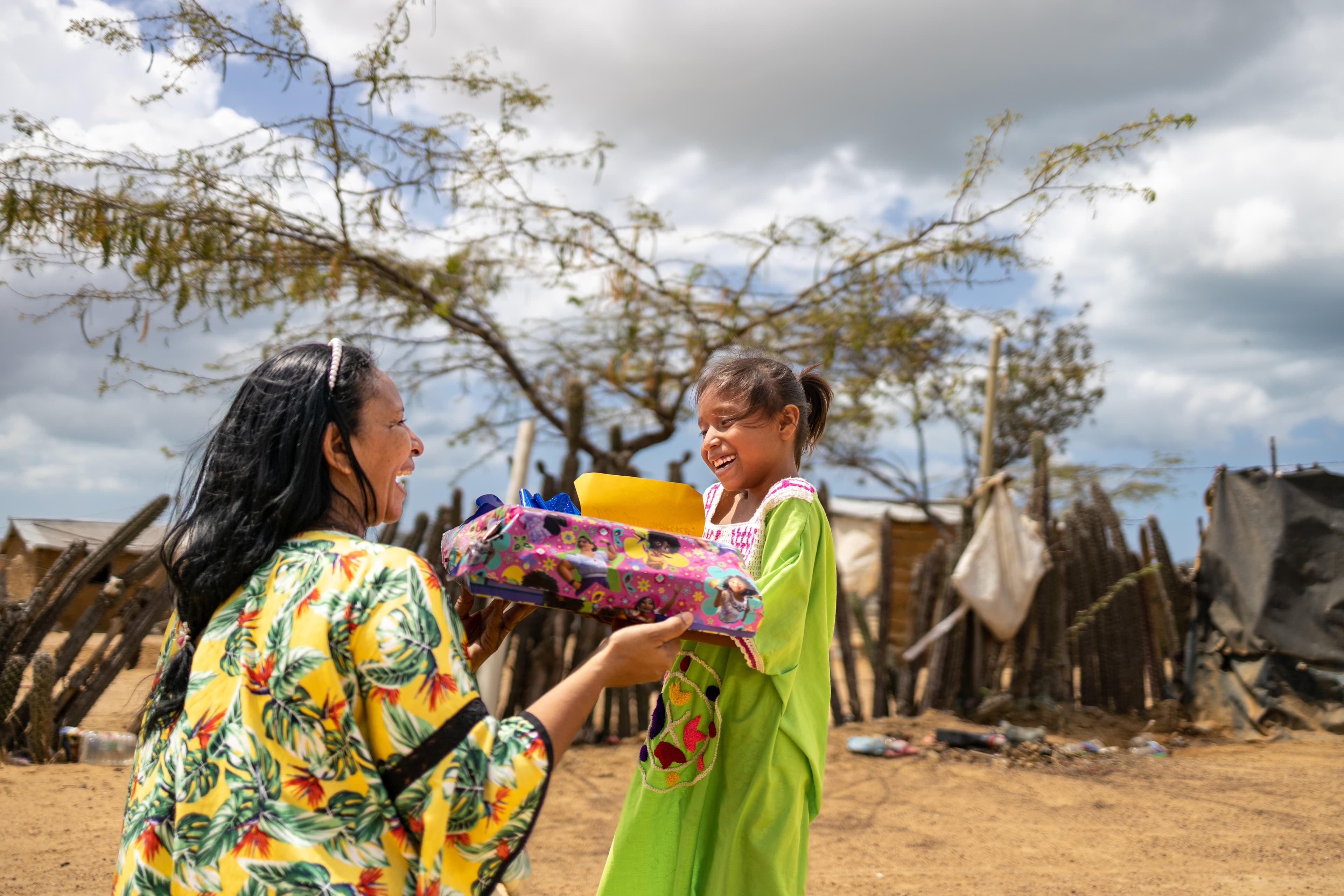 A young girl is surprised as she receives a gift for the first time from her sponsor.
