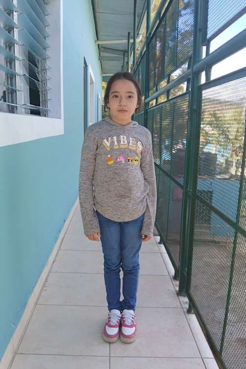 An unsponsored girl named Maryini from Honduras who has waited 543 days for a sponsor.