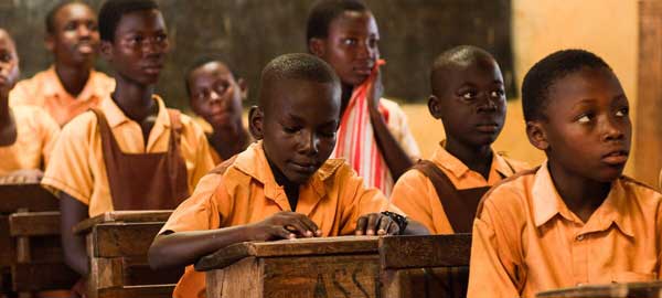 Children learning in school while sitting at their desks