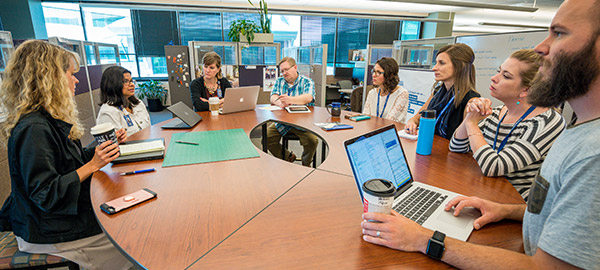 A group of Compassion employees having a meeting