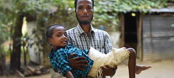 A man holding an injured child