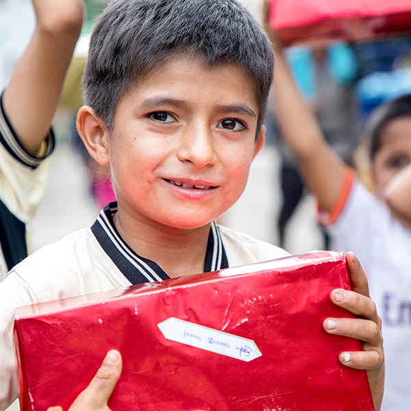 a boy holding a wrapped present
