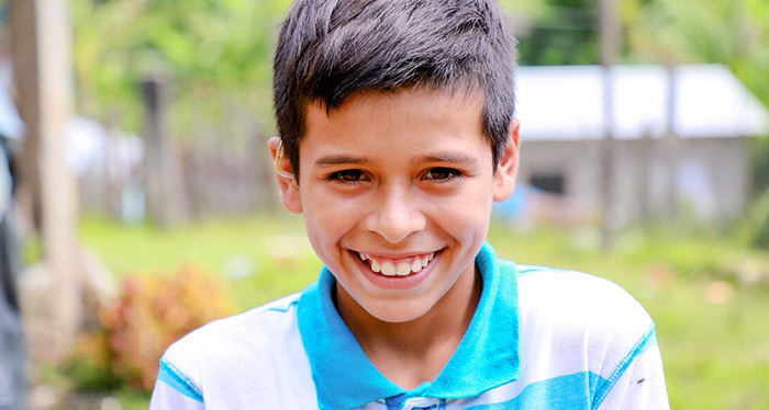 Denis smiles while outside