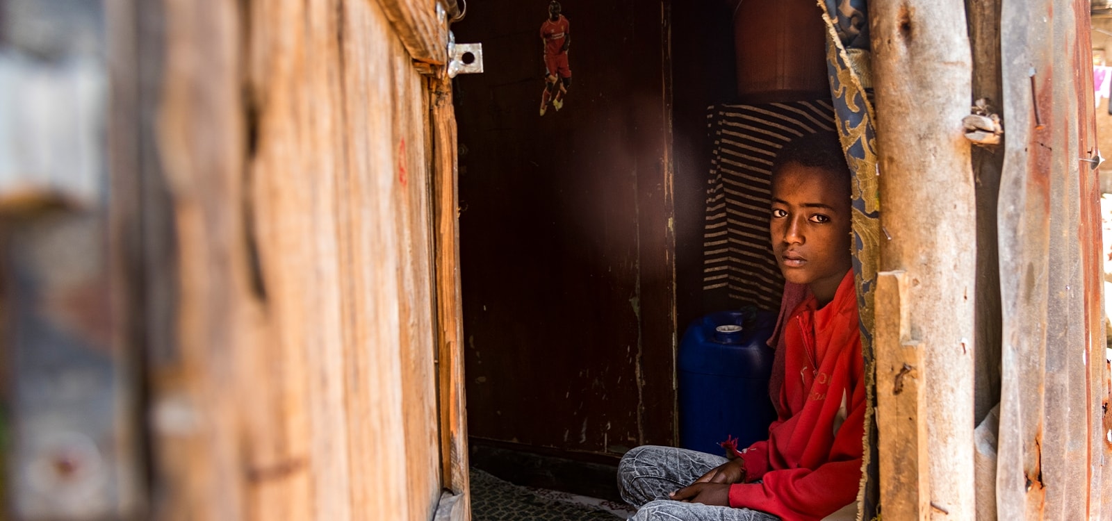 a boy sits in his room