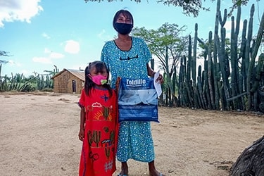 a girl and her mother hold a mosquito net