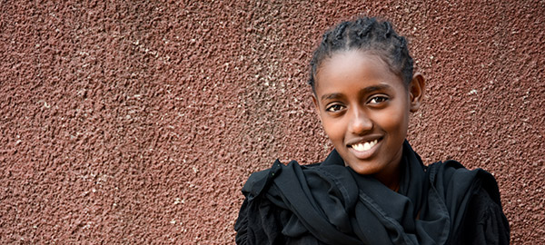 A young Ethiopian woman wearing a black top 